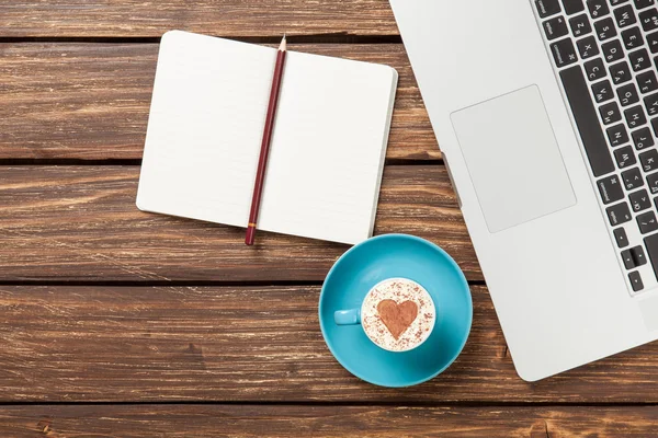 Cappuccino and notebook near laptop — Stock Photo, Image