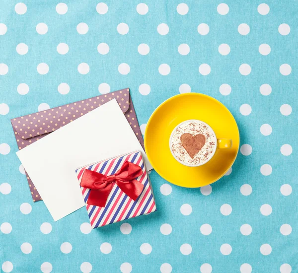 Cappuccino and envelope with gift box — Stock Photo, Image