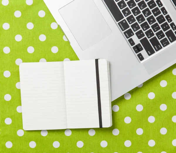 Note with laptop on polka dot — Stock Photo, Image