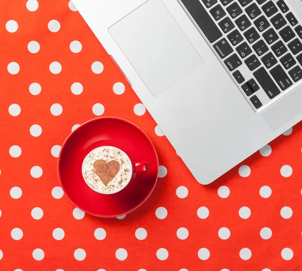 Cappuccino with heart shape and laptop — Stock Photo, Image