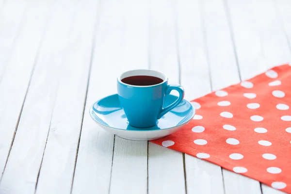 Cup of coffee on polka dot napkin — Stock Photo, Image