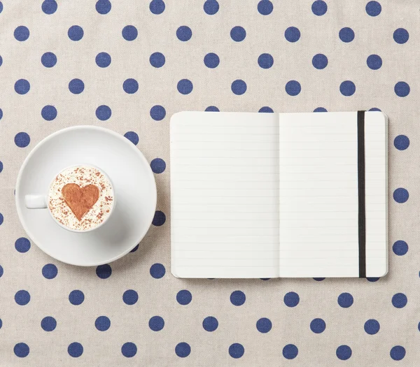 Cup of coffee and notebook — Stock Photo, Image