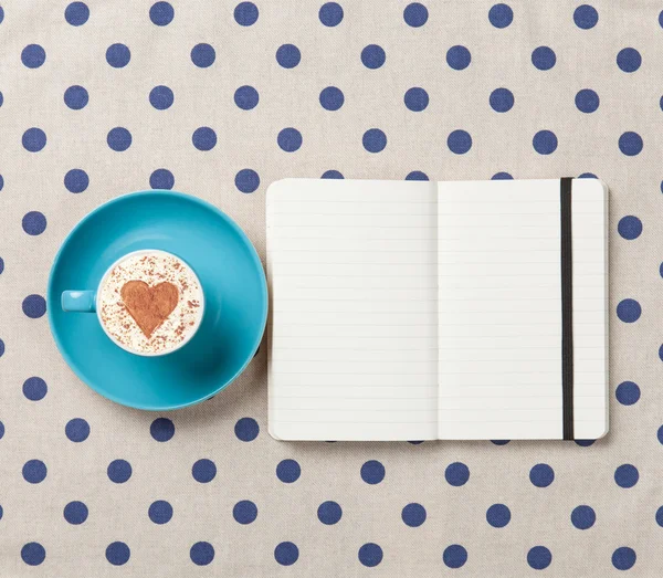 Cup of coffee and notebook — Stock Photo, Image