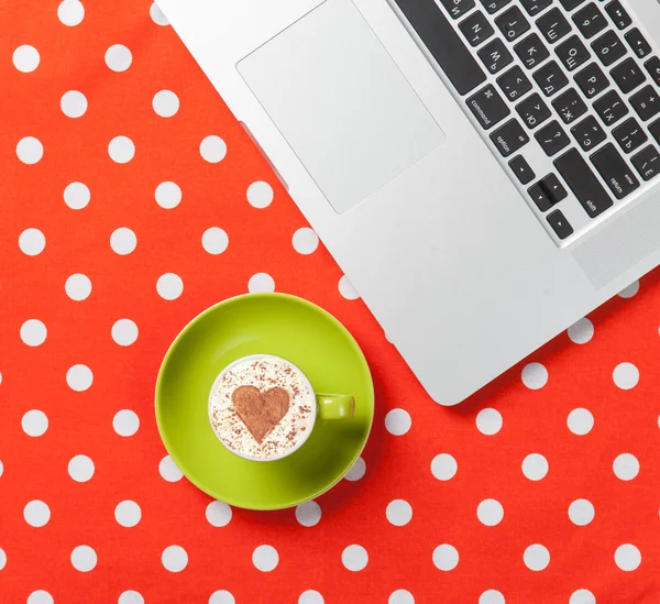 Cappuccino with heart shape and laptop — Stock Photo, Image