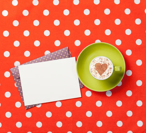 Cup of cappuccino with heart shape and envelope — Stock Photo, Image