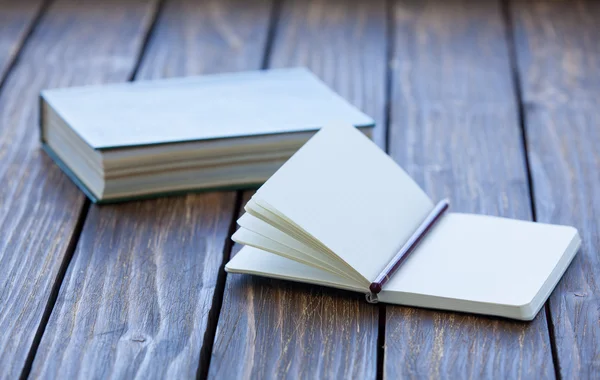 Notebook and book on background — Stock Photo, Image