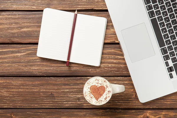 Cappuccino and notebook near laptop — Stock Photo, Image