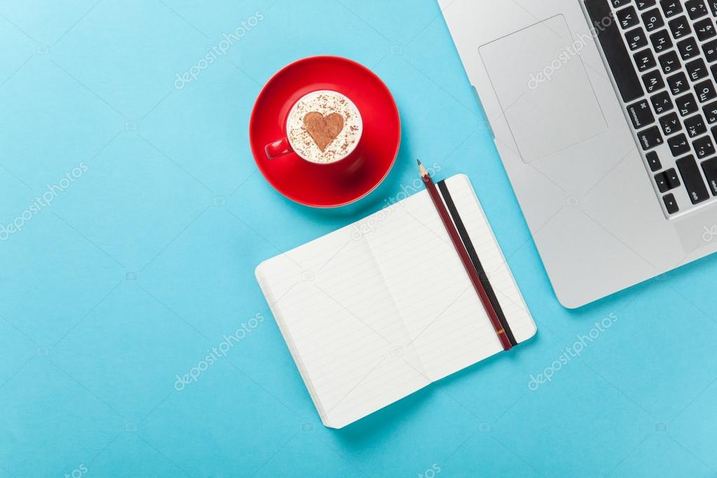 cappuccino and note near laptop
