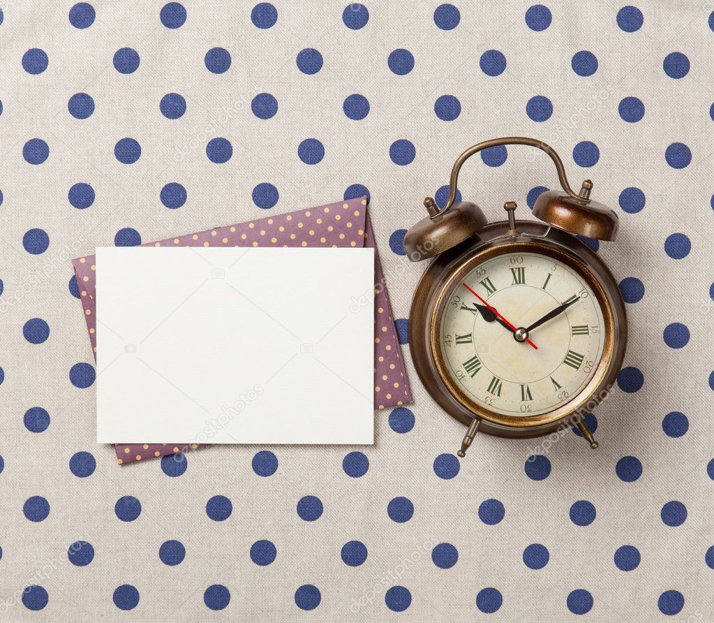 Alarm clock and envelope with letter 