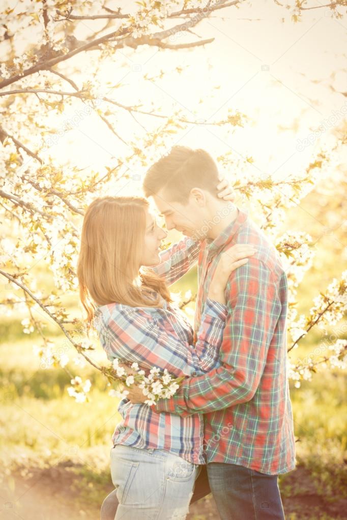 Couple in the apple trees garden