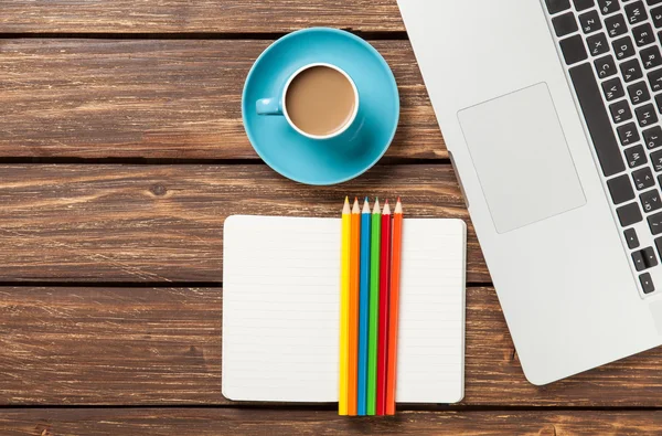 Cup of coffee and paper with laptop computer — Stock Photo, Image