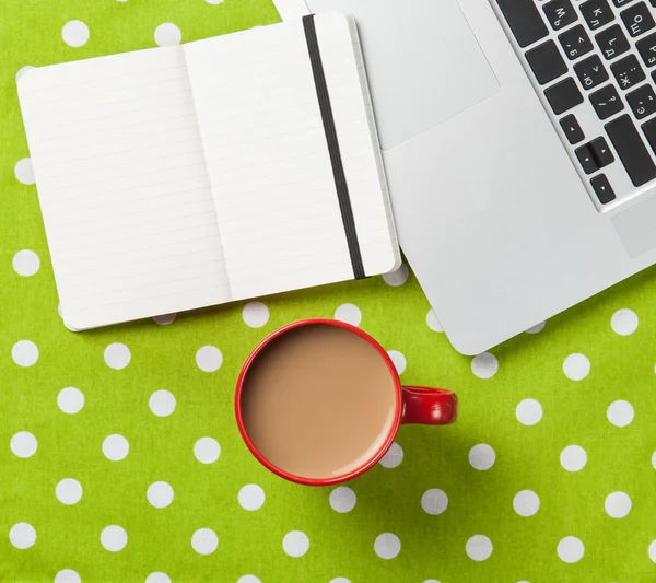 Cup and notebook near laptop comuter — Stock Photo, Image