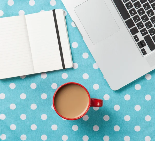 Cup and notebook near laptop comuter — Stock Photo, Image