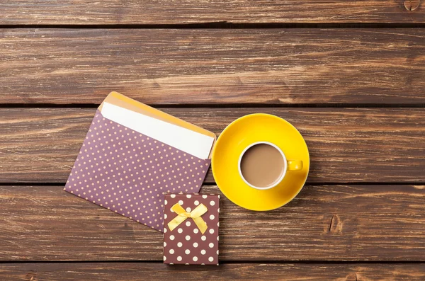 Чашка кофе и конверт с подарочной коробкой — стоковое фото