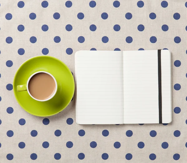 Kopje koffie en notebook — Stockfoto