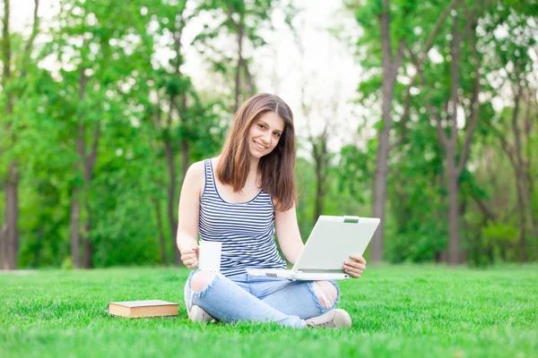 Student with laptop computer and cup — Stock Photo, Image