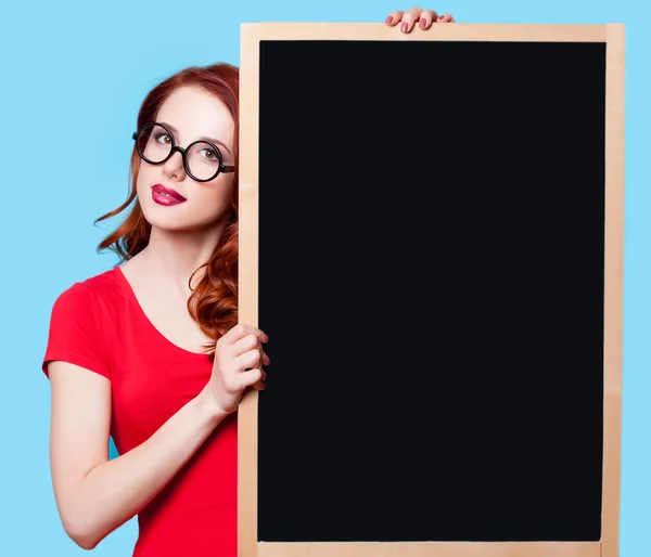 Girl in red dress with blackboard — Stock Photo, Image