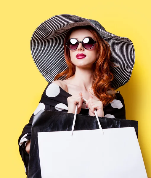 Girl in dress and hat with bags — Stock Photo, Image