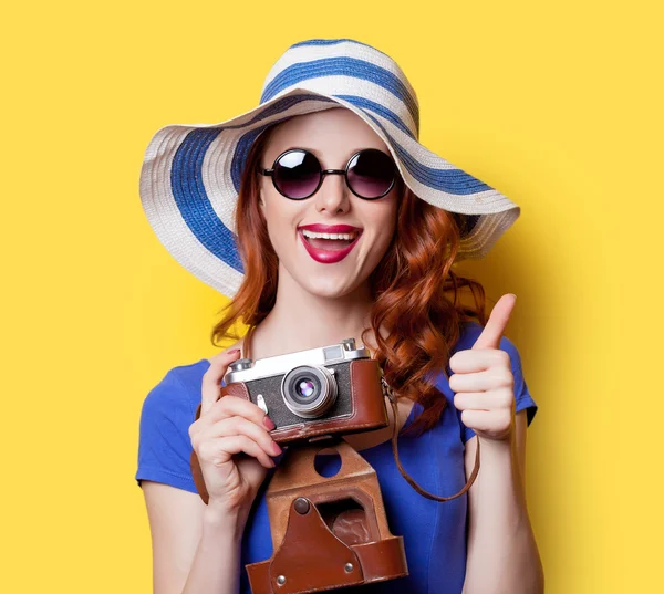 Girl in blue dress with camera — Stock Photo, Image