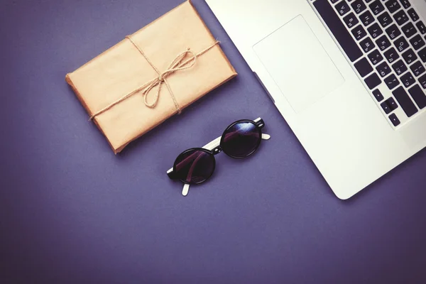 Package and laptop computer with glasses — Stock Photo, Image