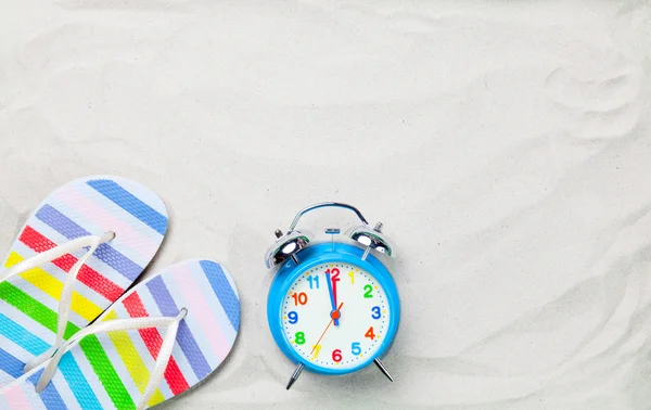 Colorful flip flops and alarm clock — Stock Photo, Image