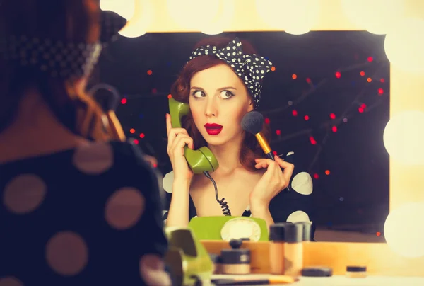 Woman with dial phone applying cosmetics — Stock Photo, Image