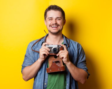 guy in t-shirt with retro camera