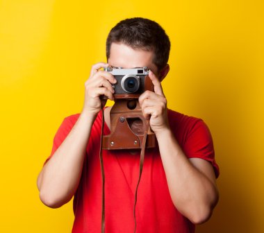 guy in t-shirt with retro camera