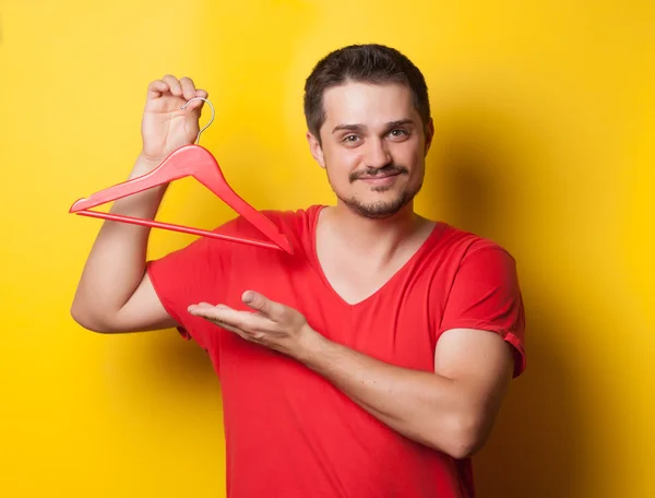 Guy in t-shirt with hanger — Stok fotoğraf