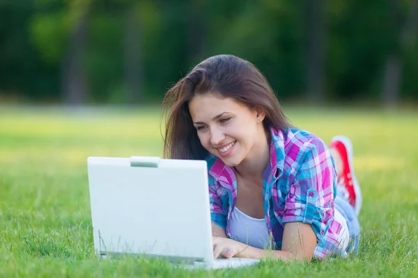 Girl with laptop computer and notebook — ストック写真