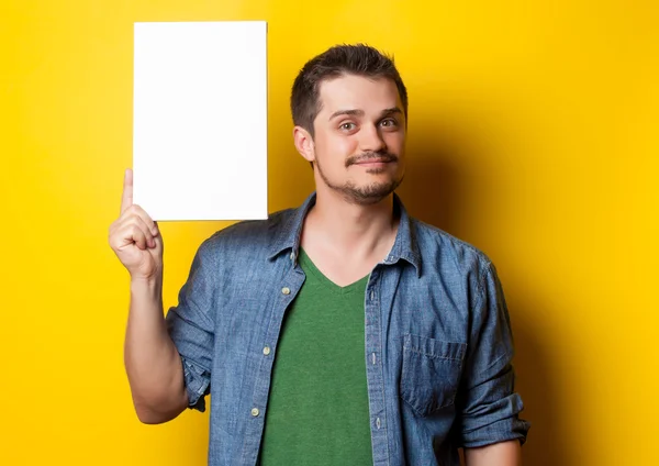 Smiling guy in shirt with white board — Stock Photo, Image