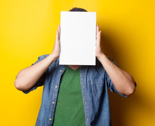 Smiling guy in shirt with white board — Stock Photo, Image