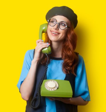 Happy redhead woman with dial phone