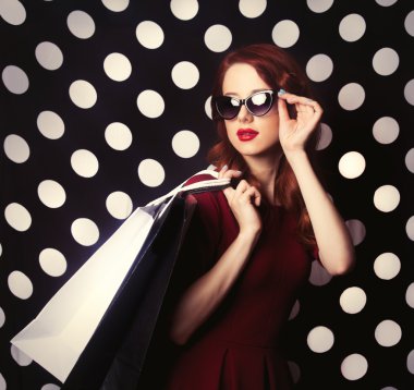Portrait of a redhead   woman with shopping bags
