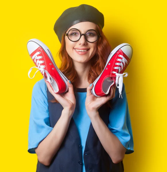 Smiling redhead woman with red gumshoes — Stock Photo, Image