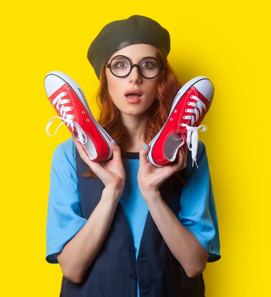 Surprised redhead woman with gumshoes — Stok fotoğraf