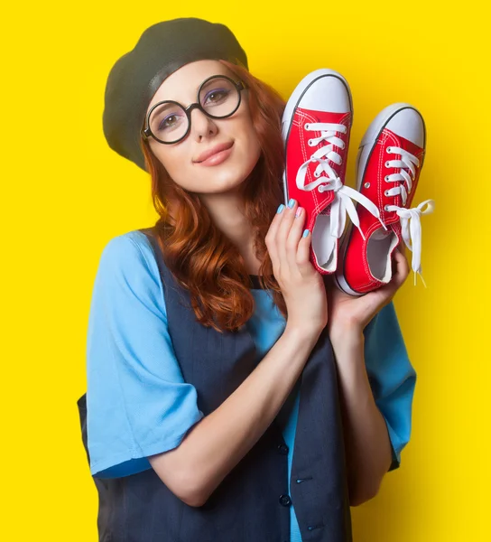 Smiling redhead woman with red gumshoes — ストック写真