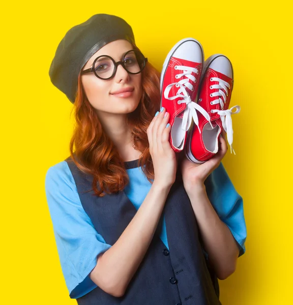 Smiling redhead woman with red gumshoes — Zdjęcie stockowe