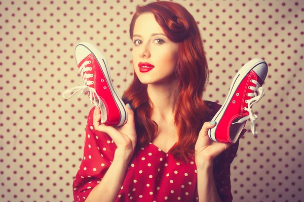 Portrait of redhead  woman with gumshoes — Stock fotografie