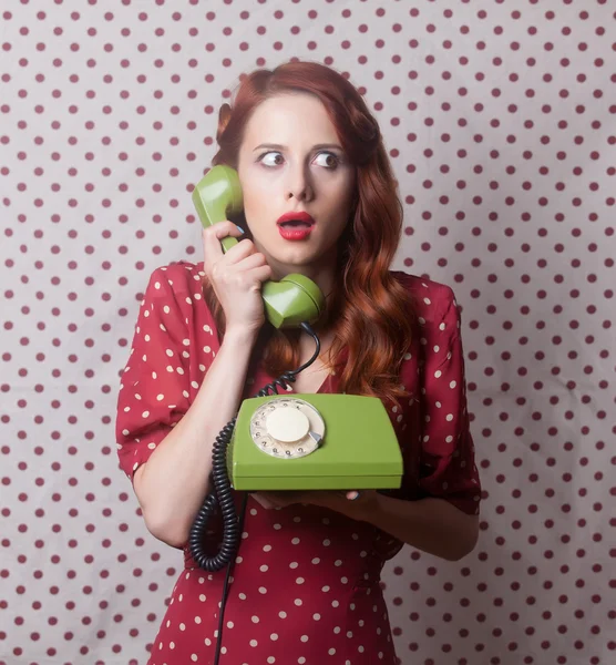 Portrait of a redhead  woman with green dial phone — Stock Photo, Image