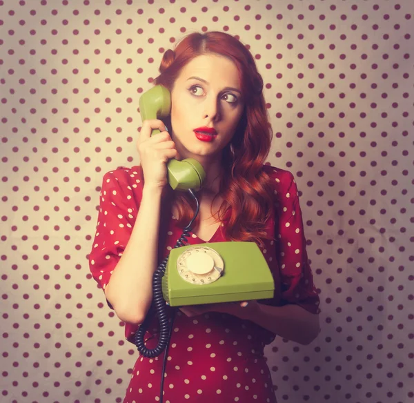 Portrait of a redhead woman with green dial phone — Stock fotografie