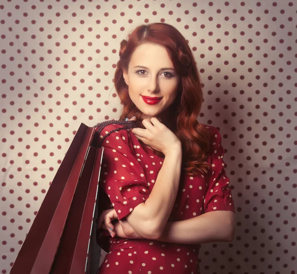 Redhead woman with shopping bags — Stock Photo, Image