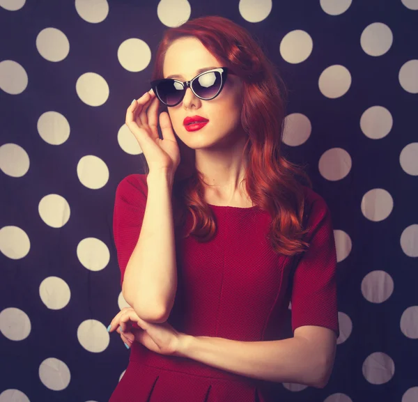 Beautiful redhead   woman in red dress — Stock Photo, Image