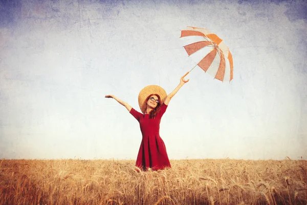 Girl in red dress with umbrella and hat — Stock Photo, Image