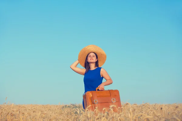 Girl with suitcase at wheat field — Stock Photo, Image