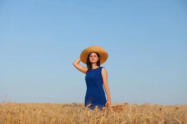 Girl with suitcase at wheat field — Stock Photo, Image