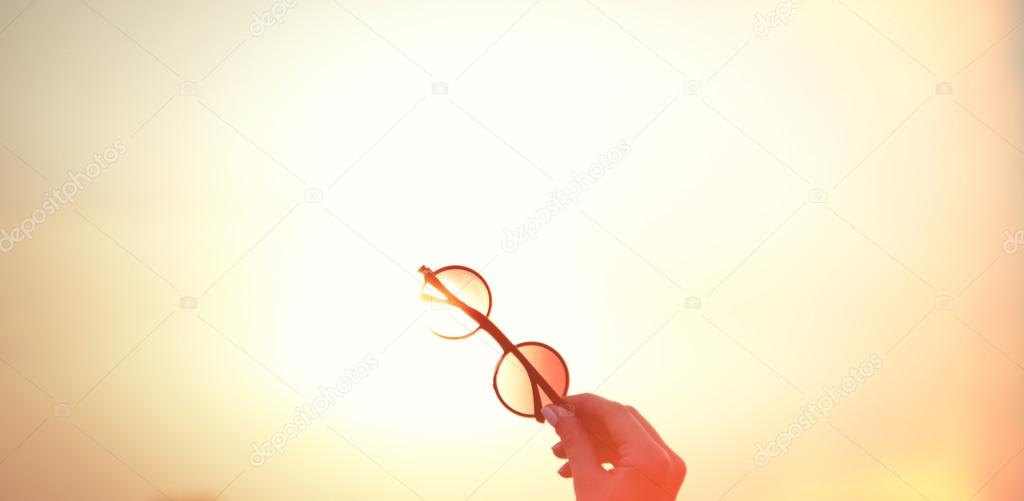 Female holding sunglasses 