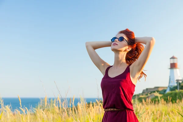 Girl with sunglasses near Lighthouse — Stock Photo, Image