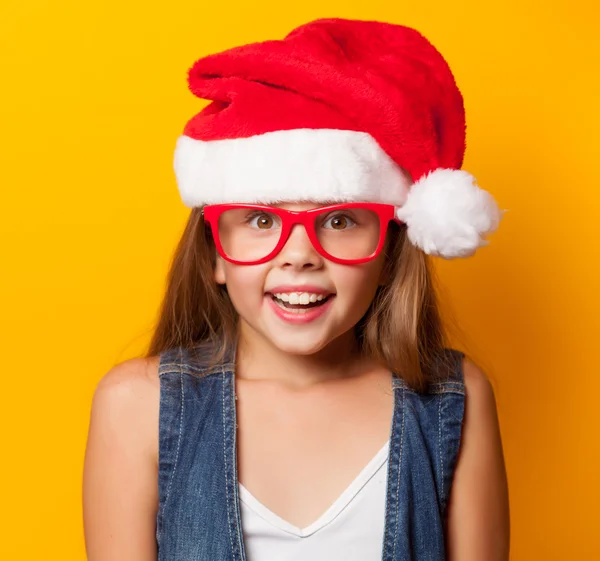 Girl in red glasses and Santas — Stock Photo, Image
