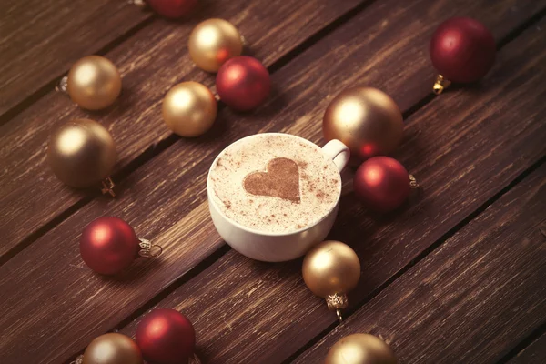 Cup of coffee and christmas bubbles — Stock Photo, Image